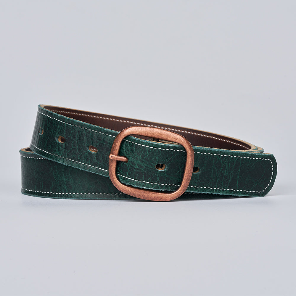 The Ember - 1.25" by Hanks Belts is a dark green leather belt with white stitching and a rectangular brass buckle, shown coiled neatly on a light gray background.