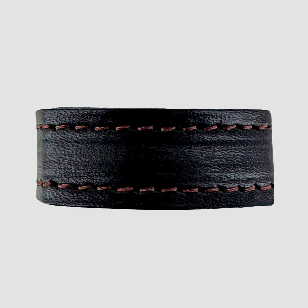 The 1.25" Stitched #10 Keeper by Hanks Belts is a wide black leather ring with brown stitching on the top and bottom edges, displayed on a plain light gray background.