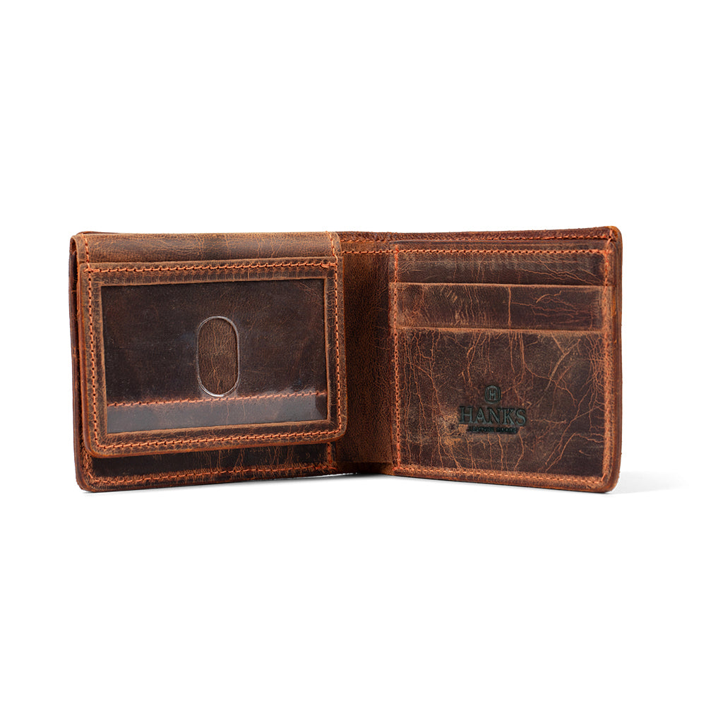 The Powell Bison Bifold with ID Window by Hanks Belts is open, showing its distressed brown leather, multiple card slots, an ID window, and the "HANKS" logo stamped inside.
