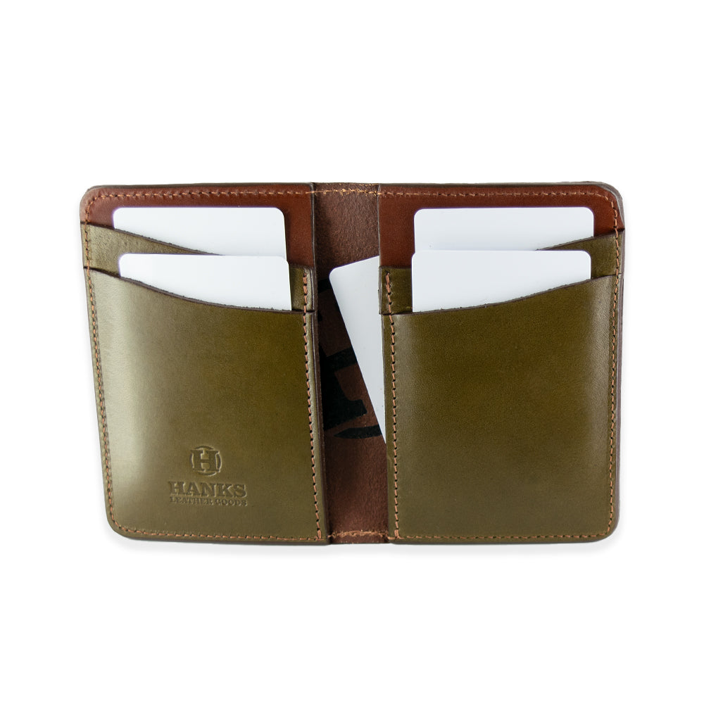 The Superior Front Pocket Bifold by Hanks Belts is handcrafted in the USA using premium English bridle leather in an open brown and olive-green design. It has six card slots, each holding a white card, with an inside flap embossed with the "HAWKS" logo for expert craftsmanship and style.