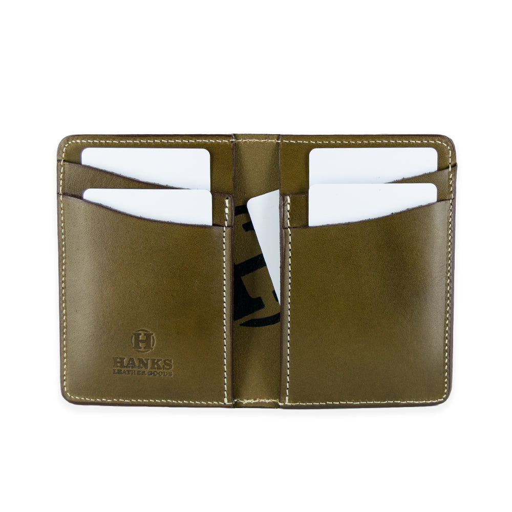 The Superior Front Pocket Bifold by Hanks Belts is a handcrafted wallet featuring an open brown leather design with visible white cards in the slots. It has neat white stitching, the Hanks Belts brand elegantly embossed on the left side, and is made from USA-tanned English bridle leather for timeless quality.