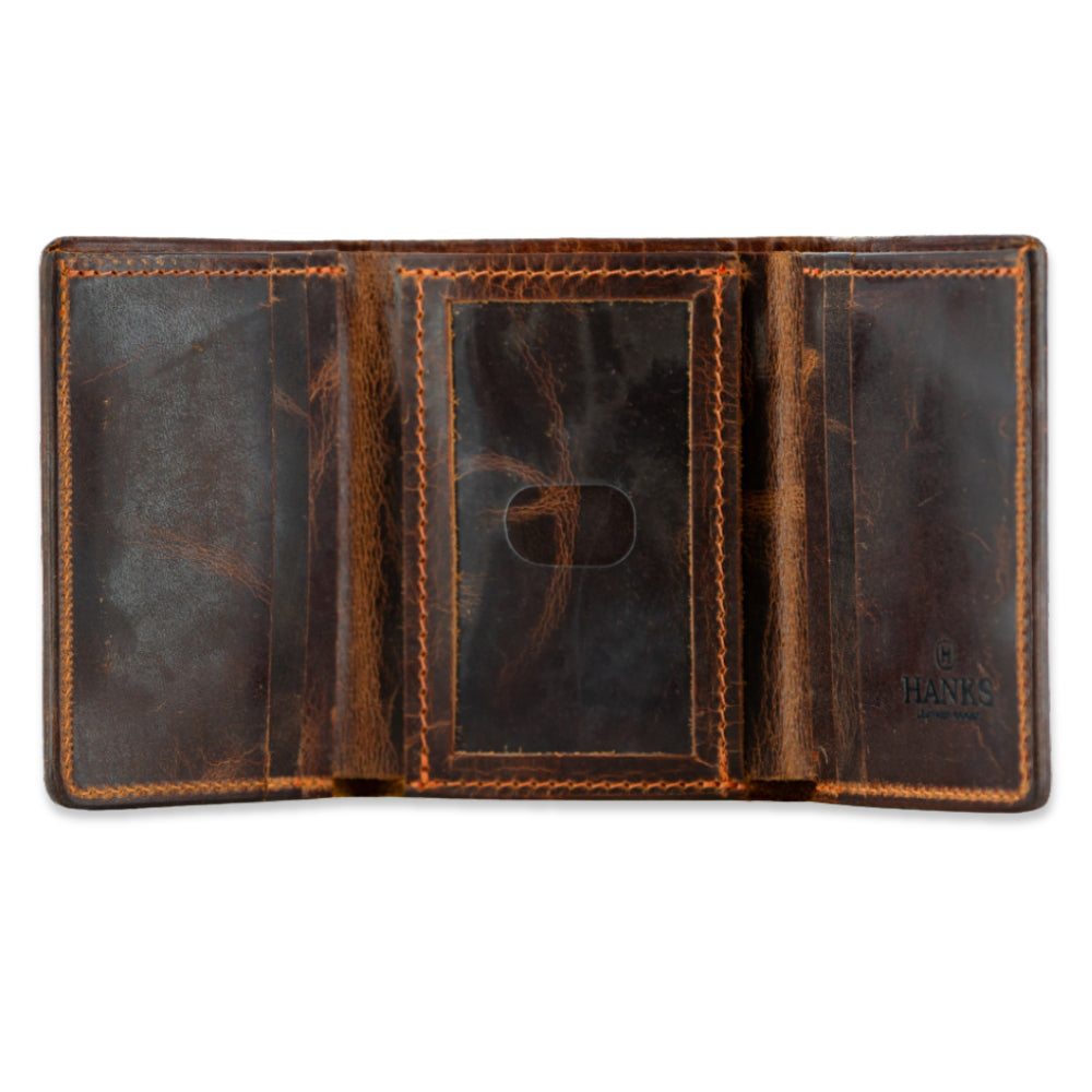 The Hanks Belts Erie Premium Bison Trifold features visible stitching, card slots on both sides, a center clear ID window, and the Hanks logo embossed in the bottom right corner of this premium bison leather wallet.