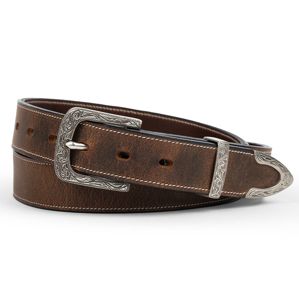 The Willow Bison by Hanks Belts is a brown women's western belt with a silver floral buckle and matching tip, subtle decorative patterns, and a durable backing.