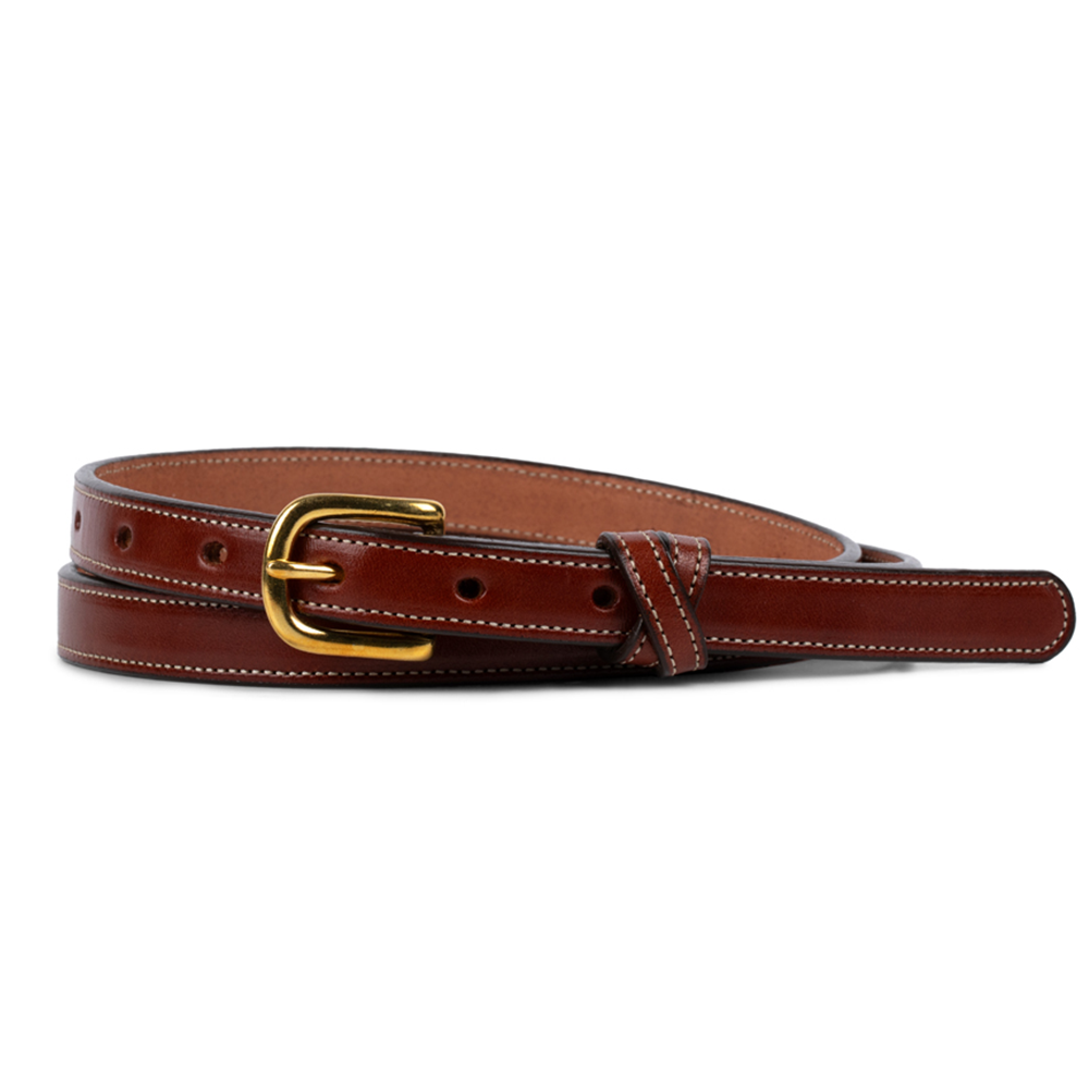 The Dixie by Hanks Belts is a women's oak belt made from premium English Bridle leather with white stitching, a gold buckle, and multiple adjustment holes, highlighting American craftsmanship. Shown coiled on a white background.