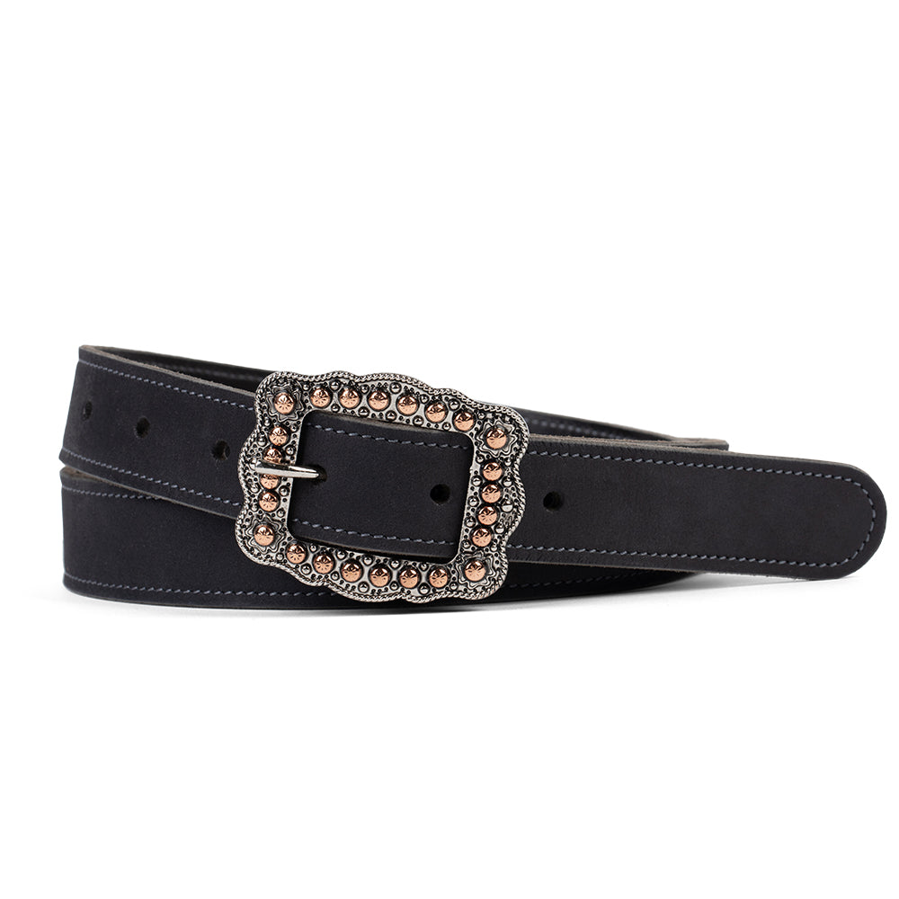 The Lennon Suede by Hanks Belts is a black suede leather belt with white stitching, an ornate silver buckle, and round bronze studs, shown coiled on a white background.