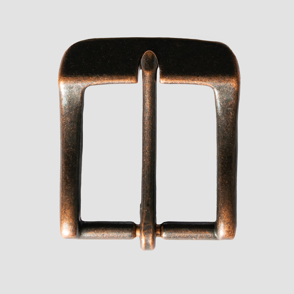 A close-up of the Hanks Belts 1.5" Antique Copper #23 Buckle, featuring a simple rectangular shape with a central prong, is shown against a plain light gray background.