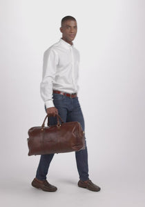Model carrying Duffel bag in brown - Showing inside