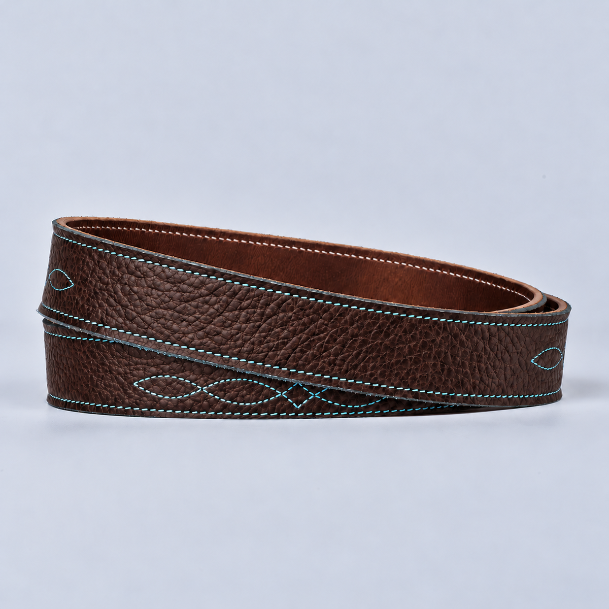Coiled brown bison leather The Yellowstone for Women 1″ with Stitched Center belt with blue stitching on light background.