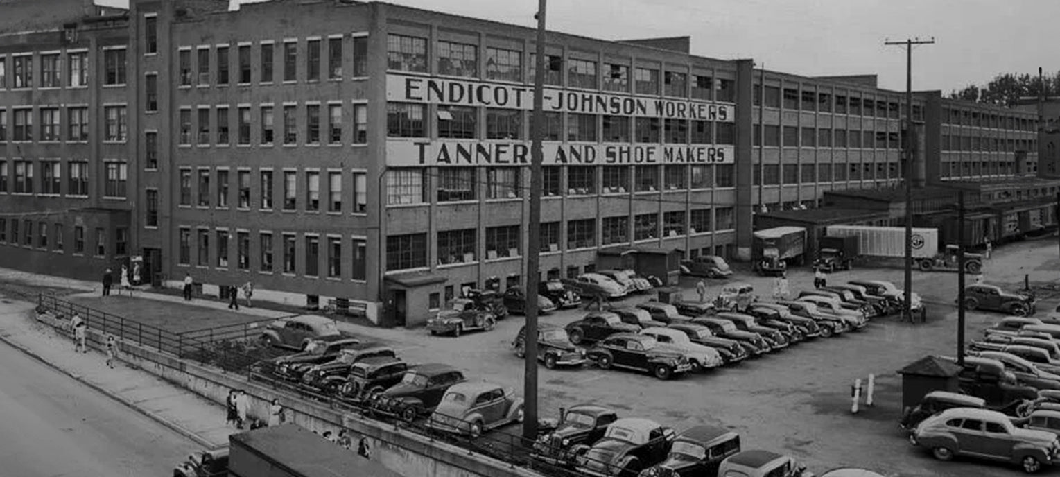 Endicott Johnson Tanners and Shoemaker building in 1920's. Image: Endicott Johnson Factory with automobiles in front. Source: George F. Johnson Memorial Library