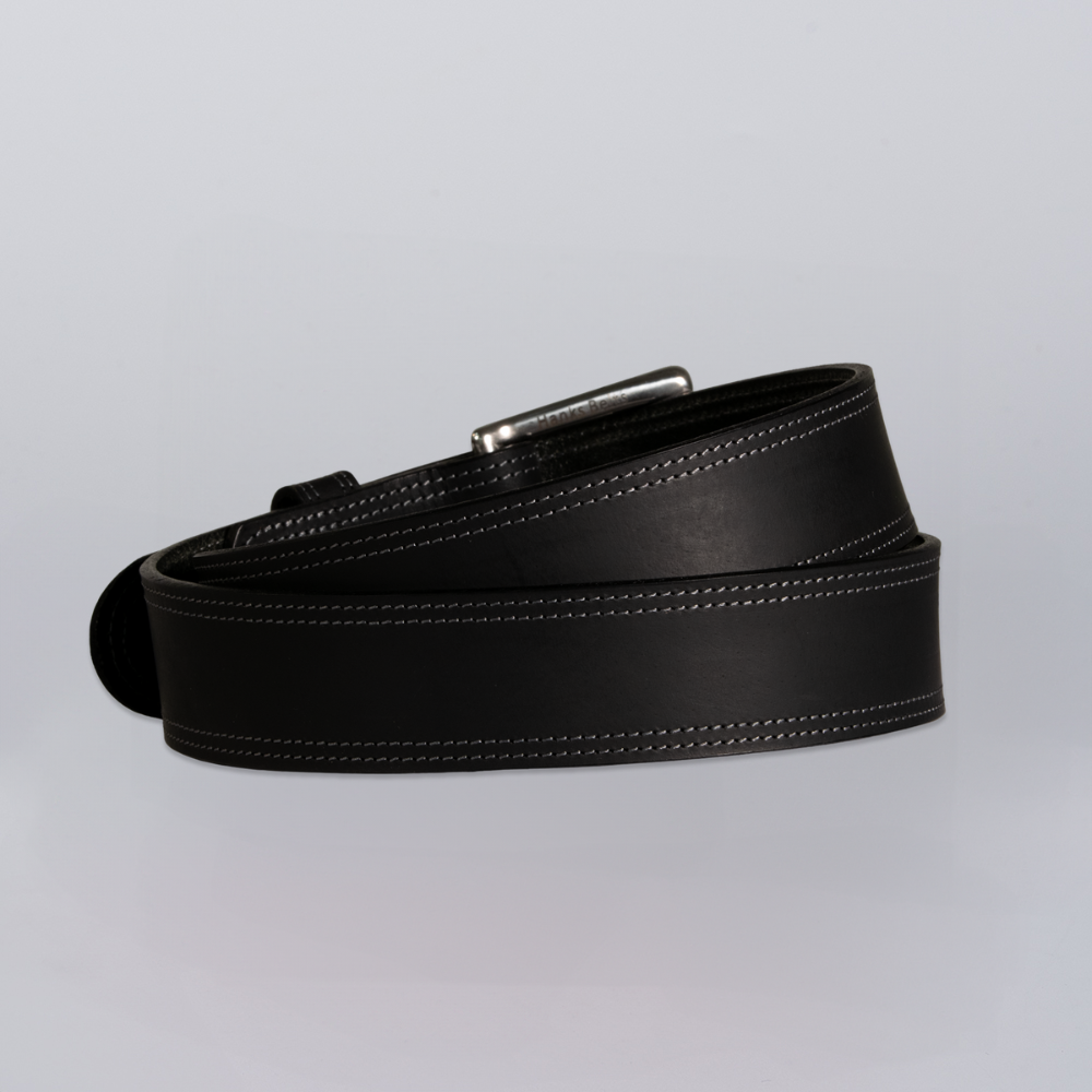The Wyoming Bison by Hanks Belts is a coiled black bison leather belt with white stitching and a silver buckle, shown on a light gray background.