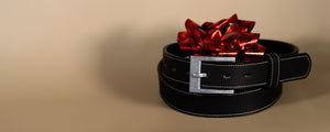Black belt with a red bow on a beige background