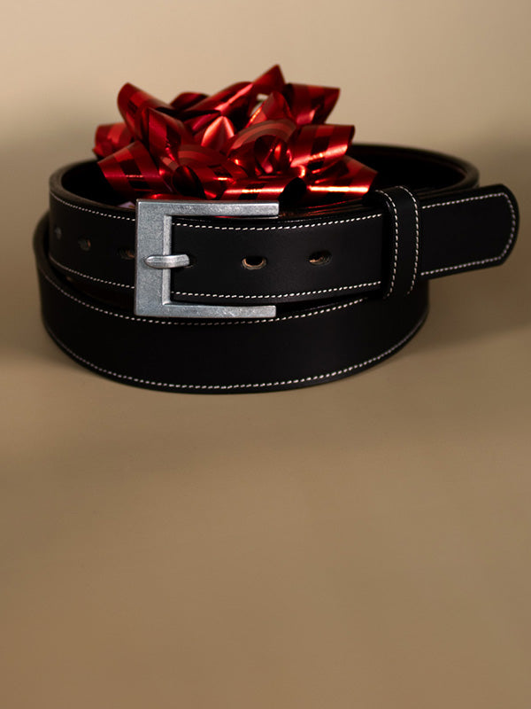 Black belt with a large red bow on a beige background