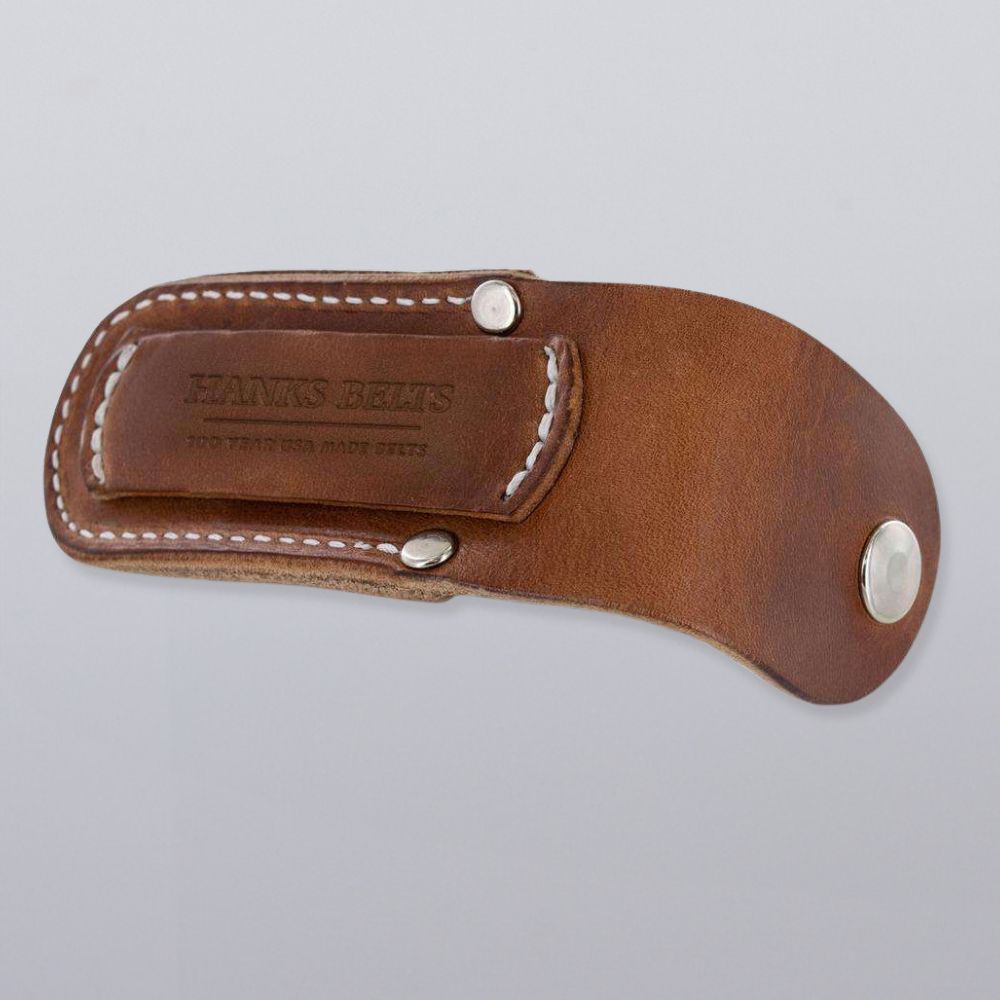 The Canyon Utility Sheath and Mag Case by Hanks Belts is made of brown bridle leather with white stitching and rivets, embossed with &quot;HANKS BELTS&quot; and &quot;TOO MANY USES TO LIST.&quot; Made in the USA, shown on a plain light gray background.