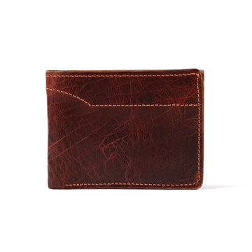 The Powell Bison Bifold with ID Window by Hanks Belts is a stylish brown bison leather wallet with visible stitching and a textured surface, featuring a small front pocket. It appears closed against a plain white background.