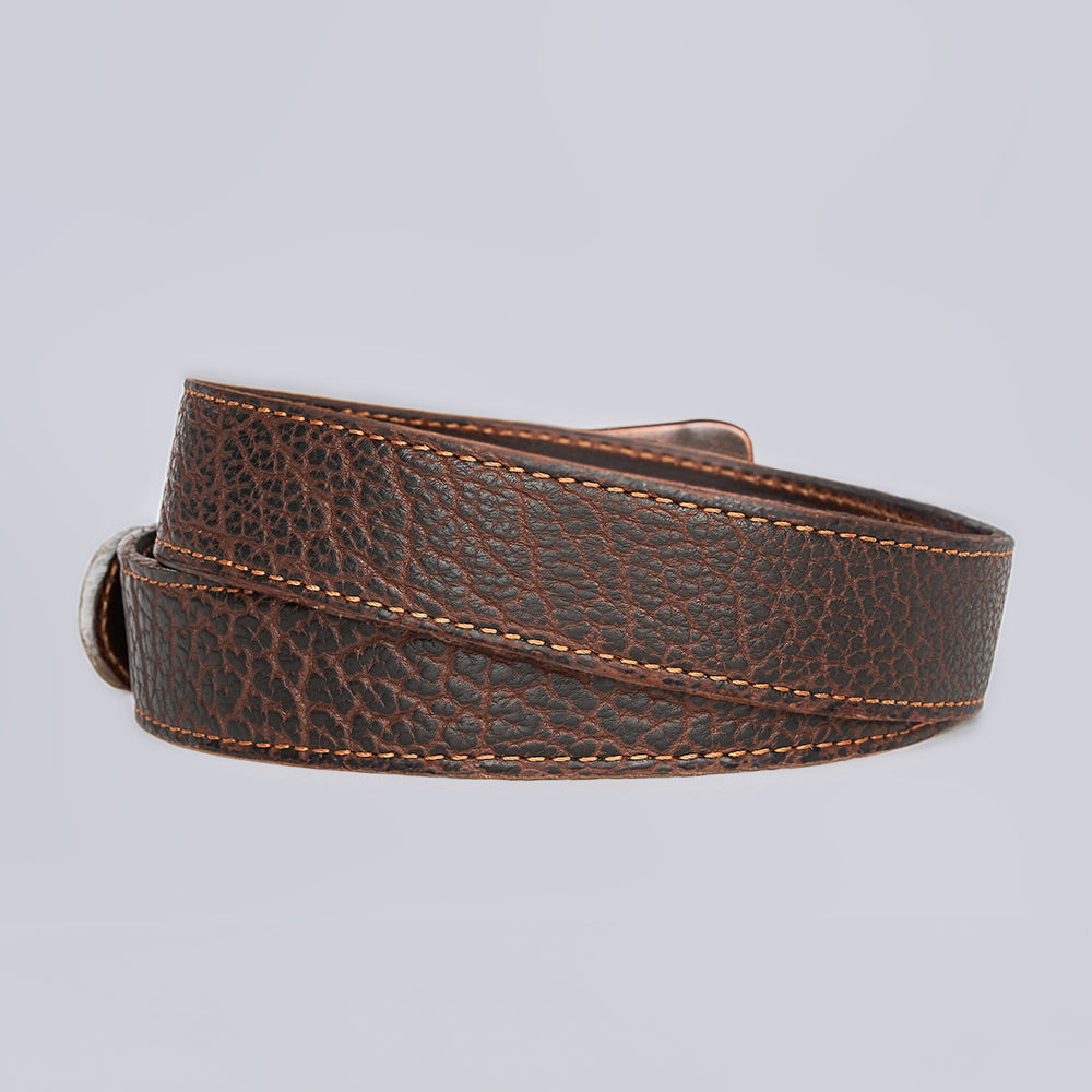 The Hanks Belts Bison Bellow is a coiled dark brown leather belt with a textured grain pattern and visible stitching, set against a plain light gray background.