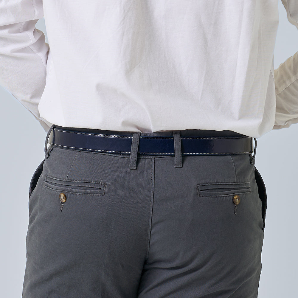 A person wearing a white shirt tucked into grey pants with buttoned back pockets and a Hanks Belts &quot;The Midnight Ranger&quot; belt, shown from the back.