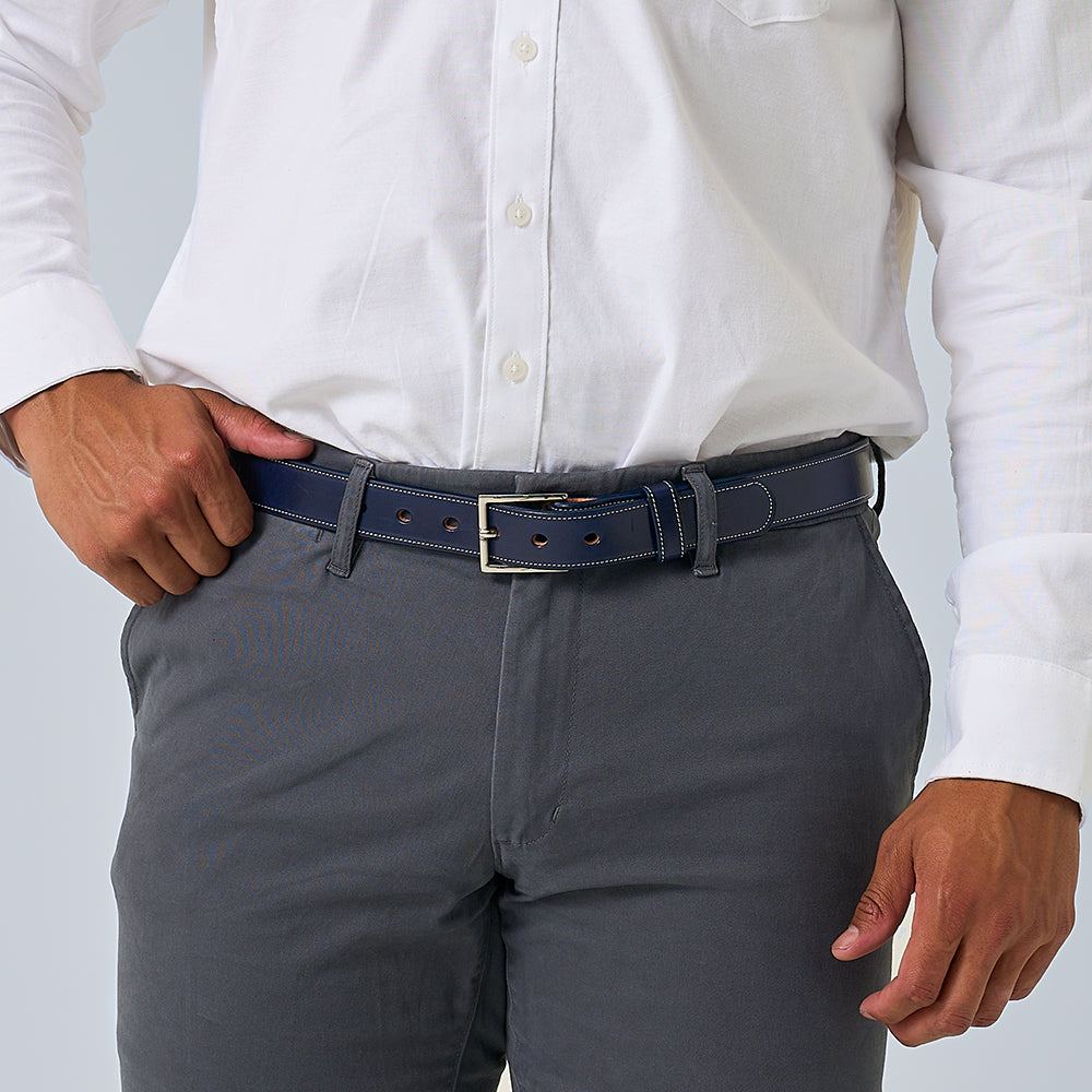 A person in a white button-up shirt tucked into gray pants wears Hanks Belts&#39; The Midnight Ranger belt; only the torso and hands are visible.