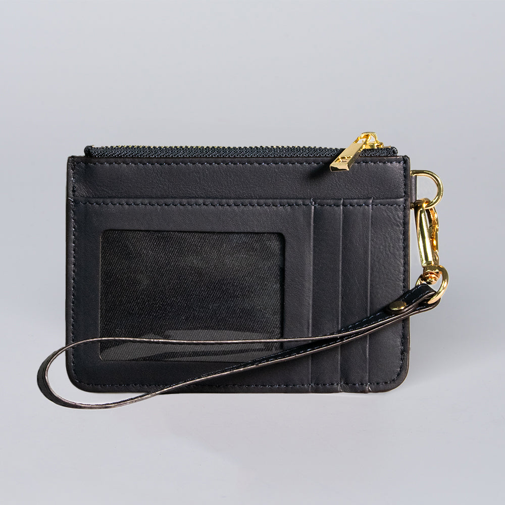 The Hanks Belts Livia Mini Wristlet is a black Italian leather wallet featuring a clear ID window, multiple card slots, gold zipper, and detachable wrist strap with a gold clasp, displayed on a plain light gray background.