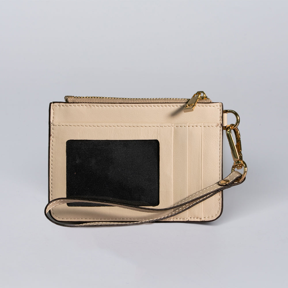 The Livia Mini Wristlet by Hanks Belts is a beige leather card wallet featuring a zipper pocket, transparent ID window, multiple card slots, and a detachable wrist strap, shown against a plain light background.