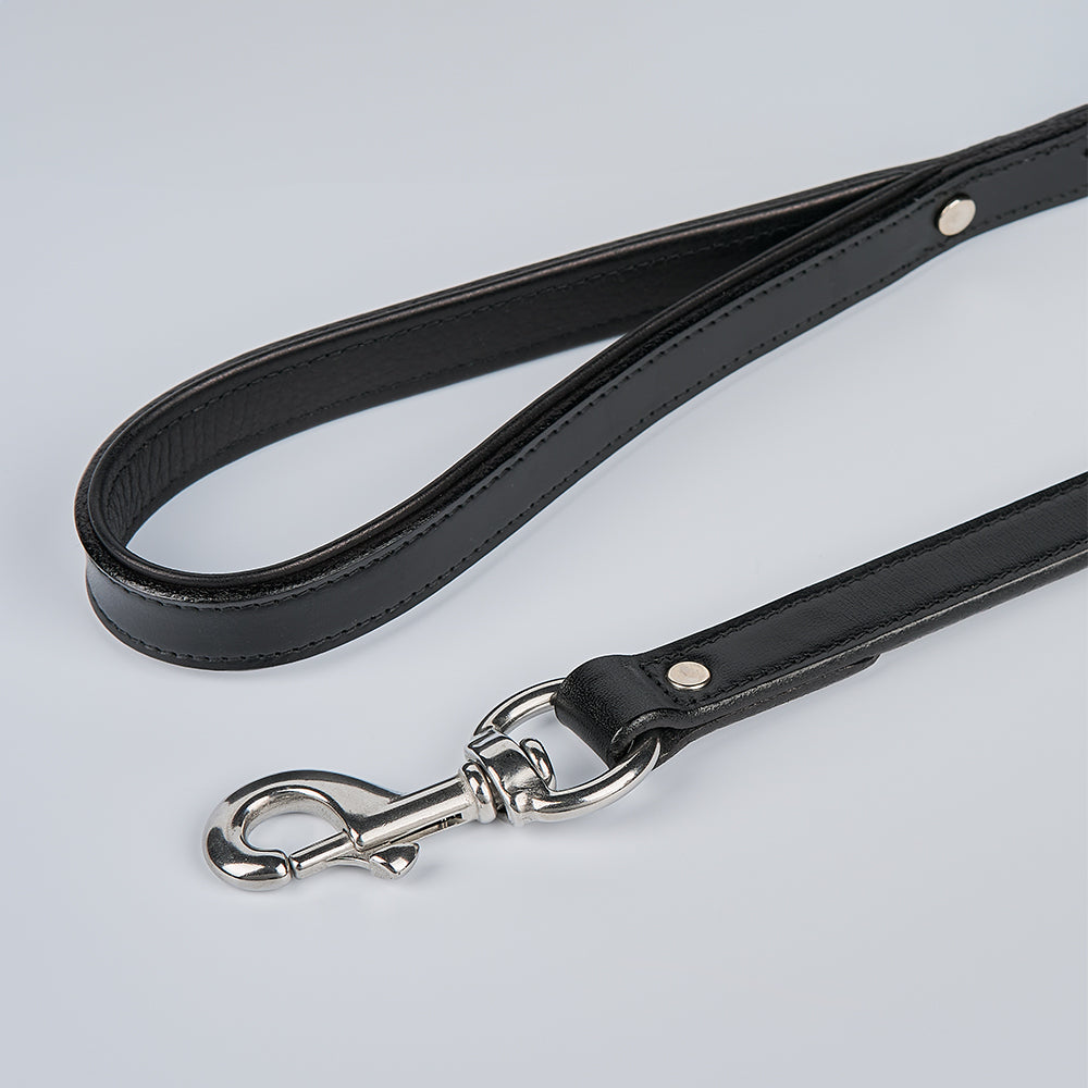 The Rover Standard Leash by Hanks Belts is a black English bridle leather dog leash with a looped padded handle and silver metal clasp, shown laid flat on a light gray background.