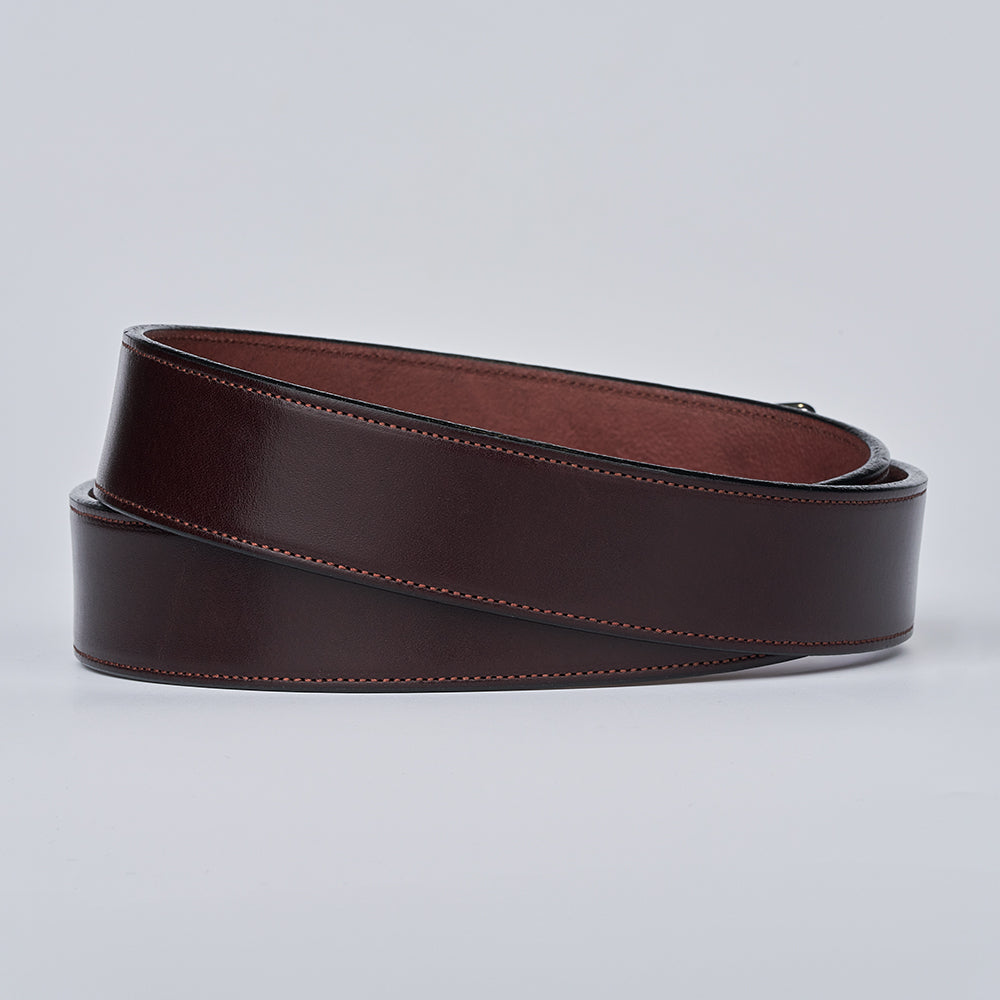 The Canyon by Hanks Belts is a handcrafted, coiled dark brown English bridle leather belt with visible edge stitching, shown on a plain light gray background.