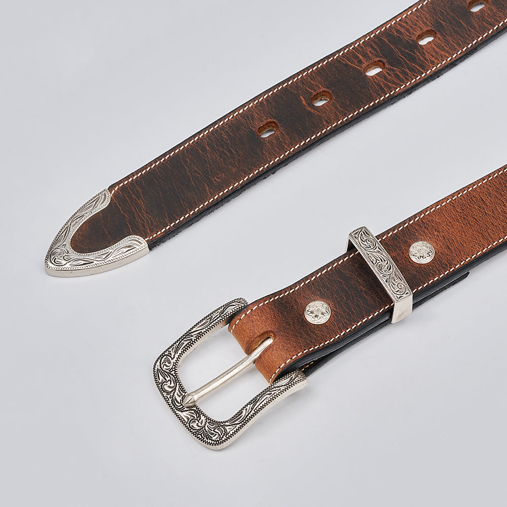 The Dakota Bison by Hanks Belts is a brown bison leather western belt with a decorative silver floral buckle, tip, and loop featuring engraved patterns and metal stud accents, shown on a light grey background.