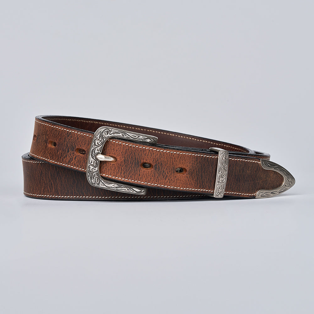 The Dakota Bison by Hanks Belts is a brown bison leather belt with a silver floral buckle set and tip, detailed with decorative edge stitching, coiled neatly on a light gray background.