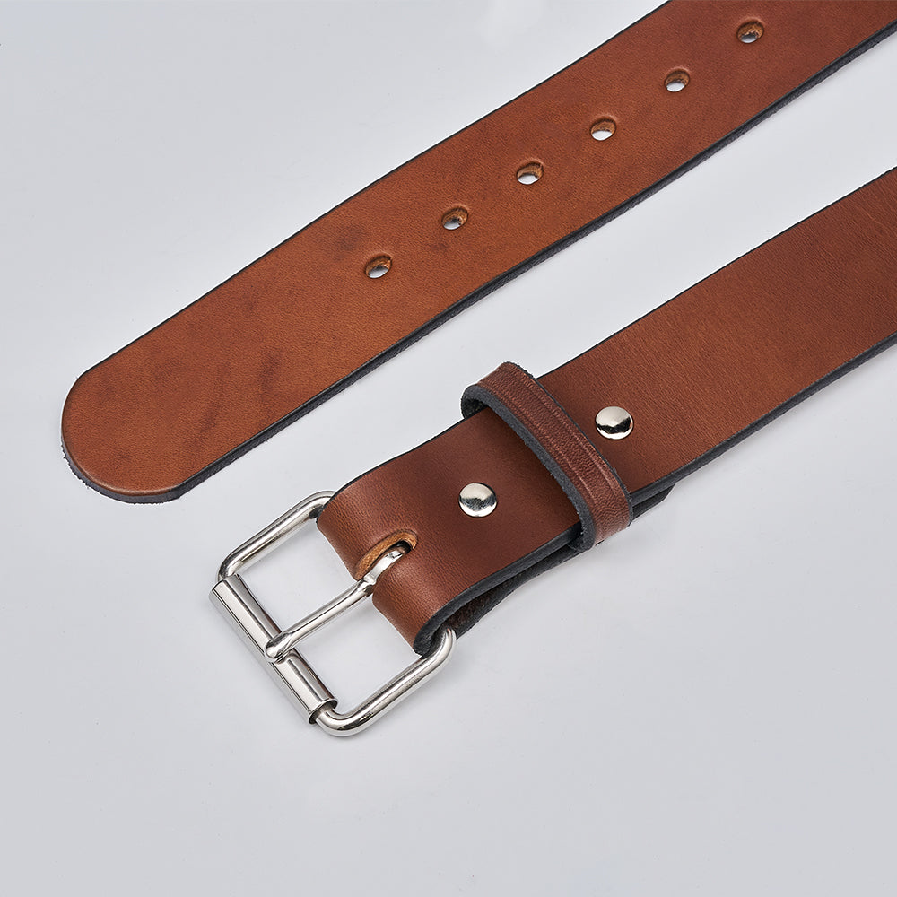 The Enforcer by Hanks Belts is a brown leather gun belt with a silver buckle and metal studs, shown flat on a white surface. This 1.75&quot; CCW belt has multiple adjustment holes along its length for concealed carry use.