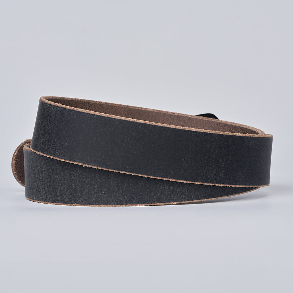 Grey leather belt with an edge on a light gray background