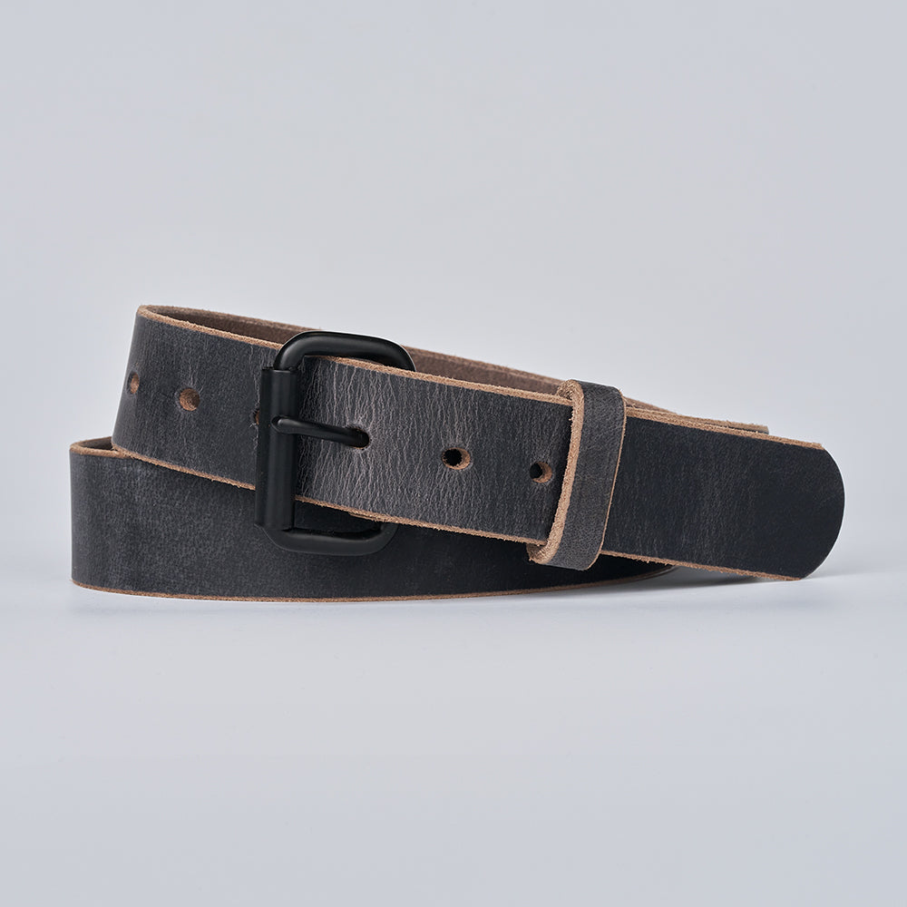 Grey leather belt with a black buckle on a light gray background