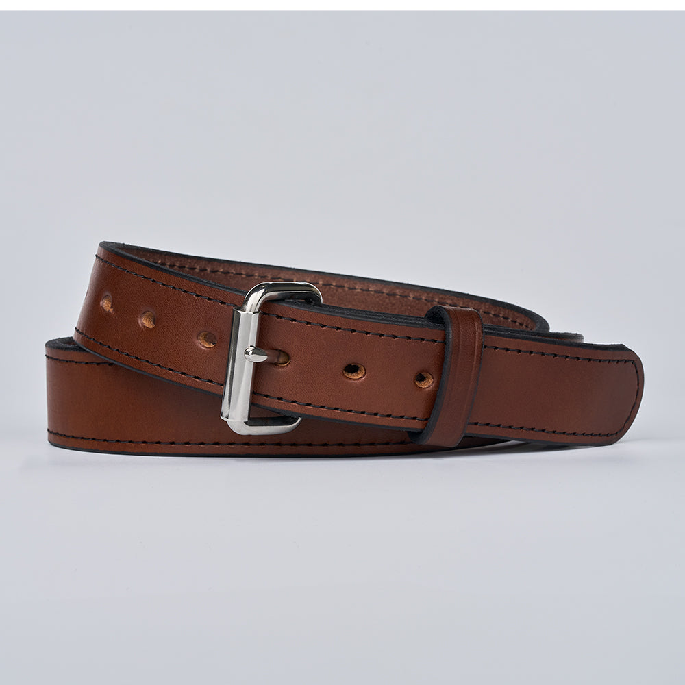 The Gunner Stitched by Hanks Belts—a coiled brown full-grain leather belt with a silver buckle—displayed on a plain light gray background.