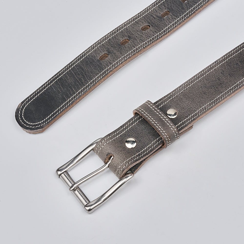 Gray leather belt with silver buckle on a light gray background