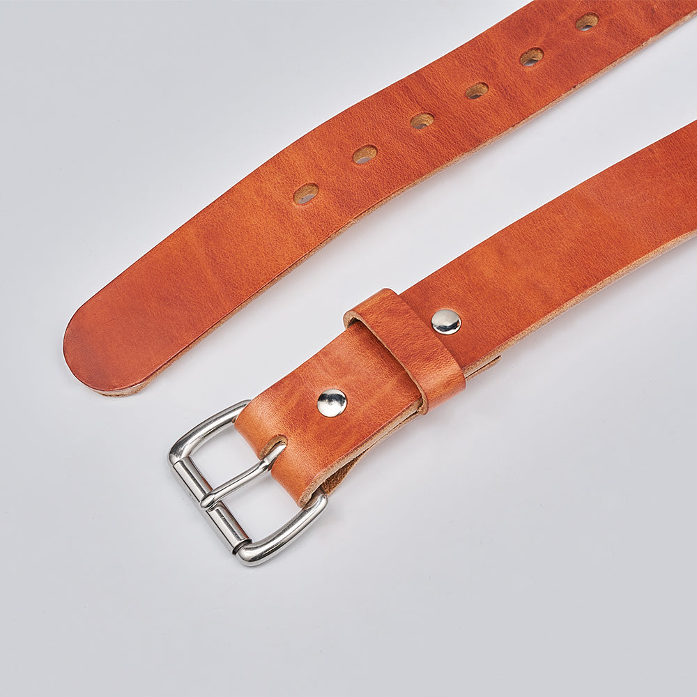 The Old World Harness by Hanks Belts is a full-grain Hermann Oak leather belt with a silver buckle. Displayed on a light gray background, it features multiple adjustment holes and a smooth, polished finish.
