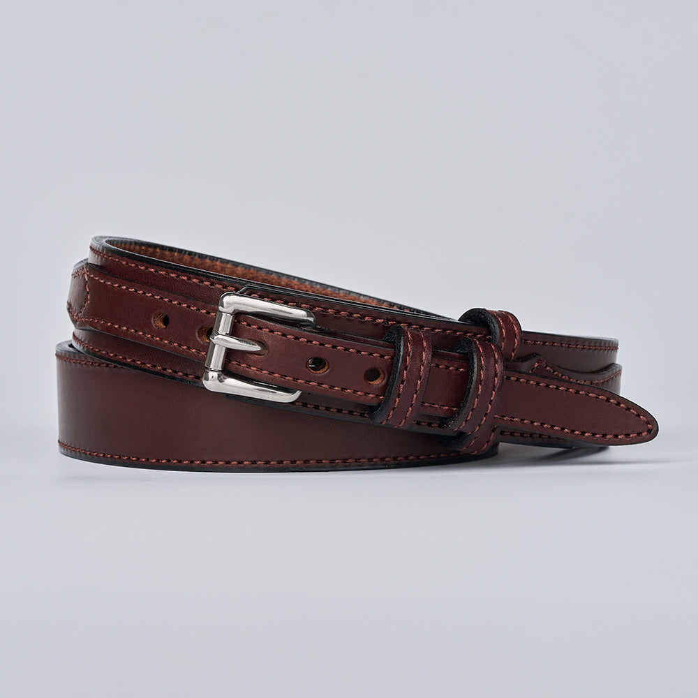 The Ranger by Hanks Belts is a brown full-grain leather belt with visible edge stitching and a silver buckle, neatly coiled on a plain light gray background.