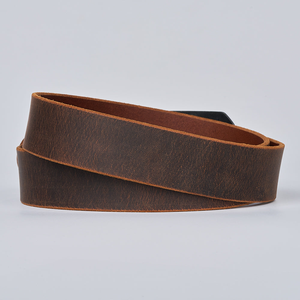 The Relic Retro Style by Hanks Belts is a coiled dark brown Water Buffalo leather belt with a smooth matte finish and unfinished edges, shown on a plain light gray background.