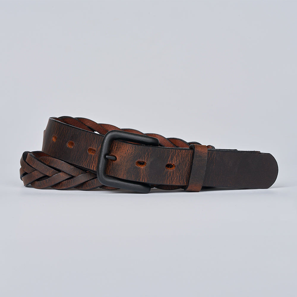 The Rockford Braided Bison by Hanks Belts, a brown braided leather belt with a black metal buckle made in the USA, is coiled on a plain light gray background.