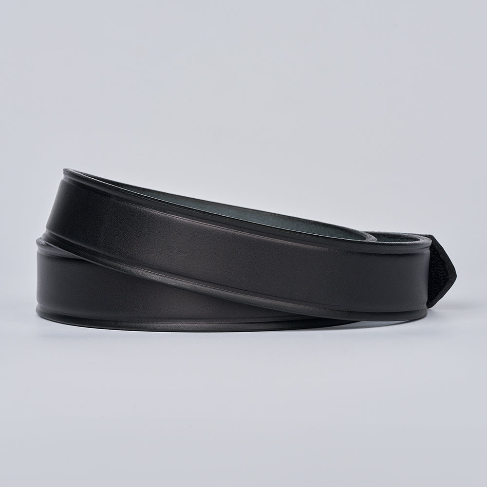 The Scratchless Mechanics by Hanks Belts, crafted from full grain leather and coiled on a plain light gray background, highlights timeless style and lasting durability.
