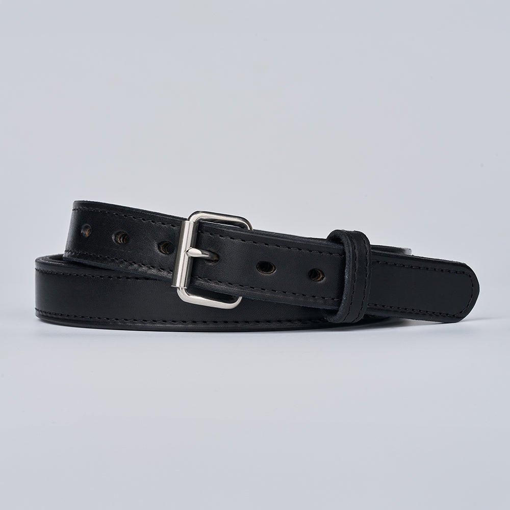 The Steel Core - 1.25&quot; by Hanks Belts is a black leather CCW belt with a silver buckle, visible stitching, and multiple adjustment holes, coiled on a plain light gray background. Designed for durability and comfortable concealed carry.