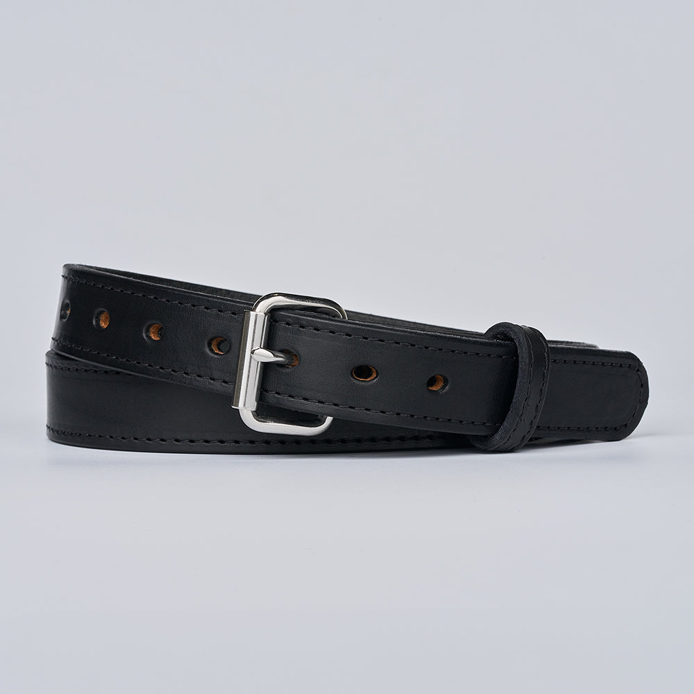 The Xtreme - 1.25" by Hanks Belts is a black leather gun belt with a silver buckle, coiled on a light gray background. It features multiple adjustment holes and visible edge stitching.