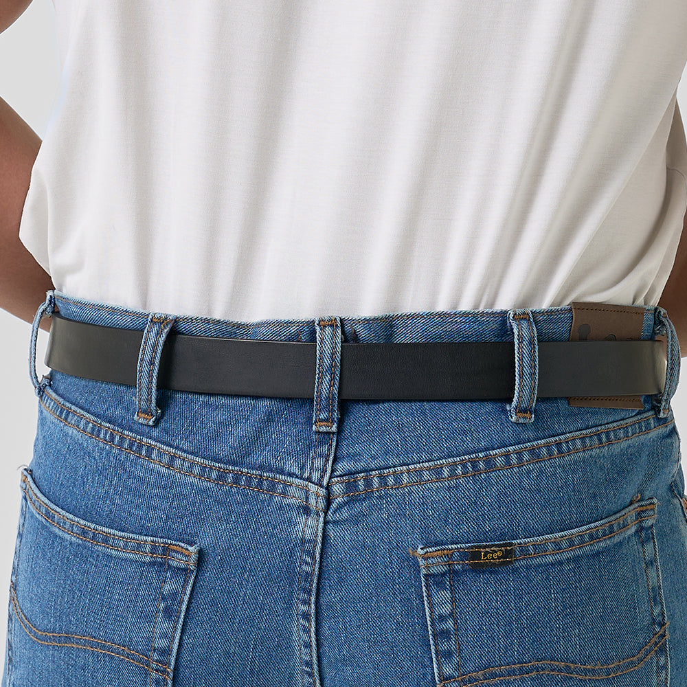A person wearing blue jeans with visible stitching and a leather brand patch, plus Hanks Belts&#39; &quot;The Deputy&quot; black concealed carry belt and a white tucked-in shirt, seen from the back.