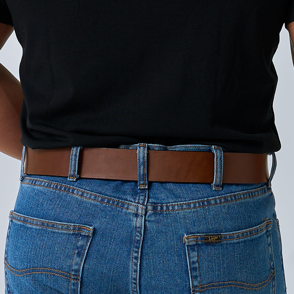 A person wearing a black shirt tucked into blue jeans with The Enforcer 1.75&quot; CCW belt by Hanks Belts, shown from the back waist down.