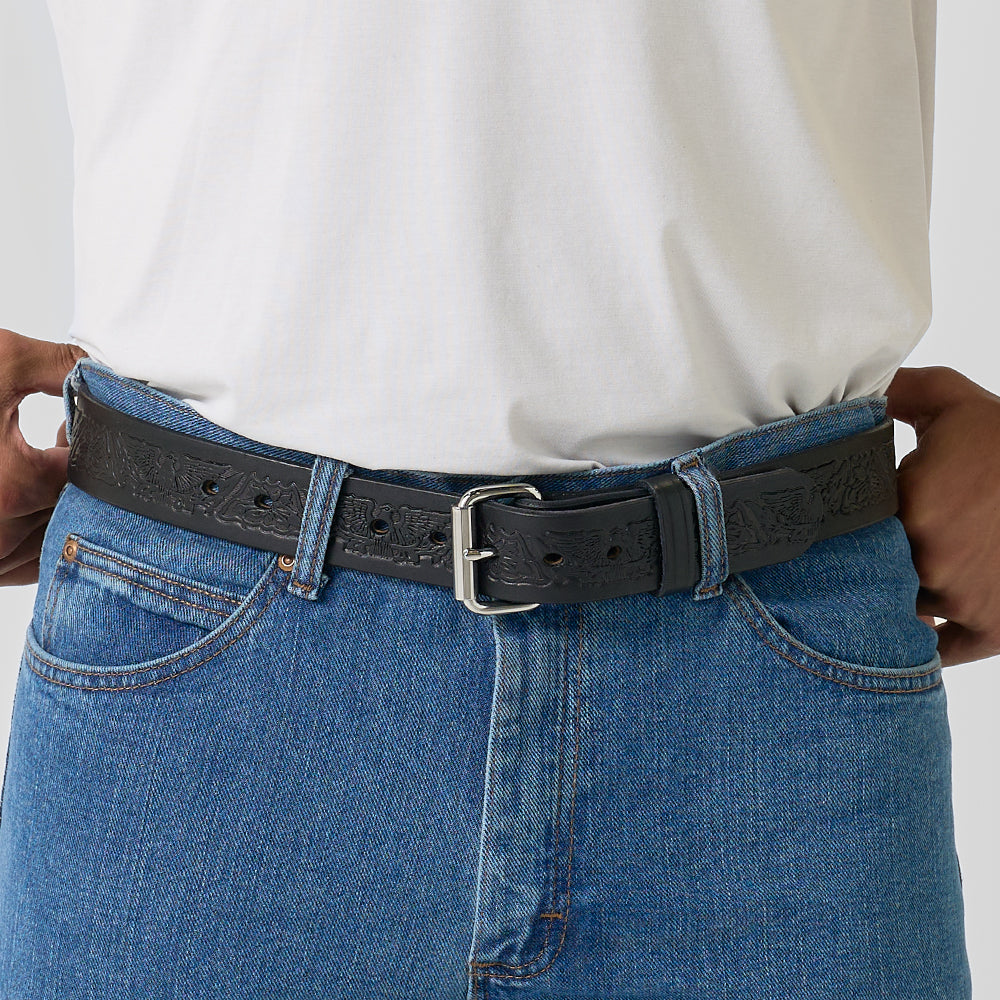 A person in blue jeans and a white t-shirt stands with hands on hips, wearing Hanks Belts&#39; The Gunner Eagle black full-grain leather CCW gun belt.