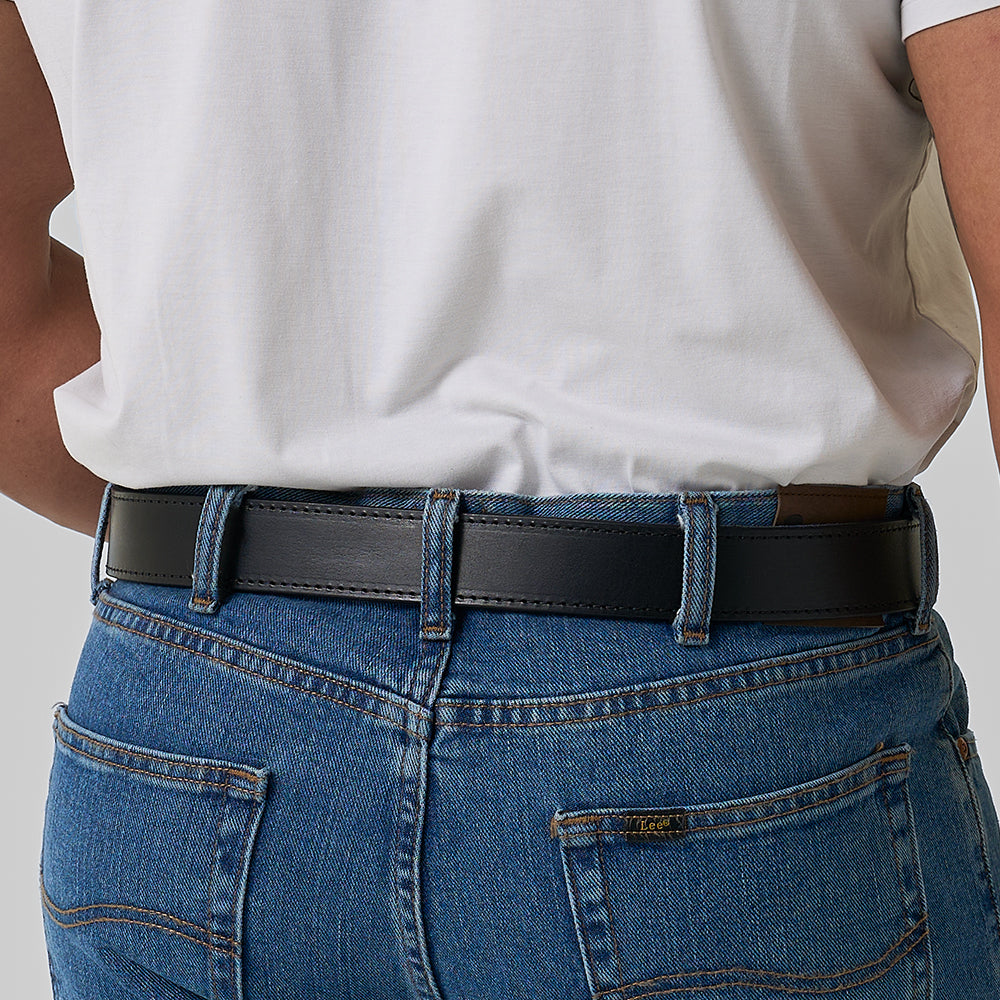 A person wearing blue jeans with brown stitching, a tucked-in white shirt, and an Hanks Belts &quot;The Gunner Stitched&quot; black full-grain leather CCW belt, seen from behind.