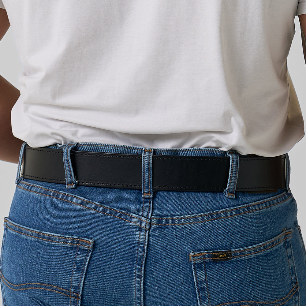 A person wearing a white t-shirt tucked into blue jeans, shown from the back. The jeans feature visible stitching and back pockets, paired with The Xtreme - 1.75&quot; heavy duty leather belt by Hanks Belts for added support and style.
