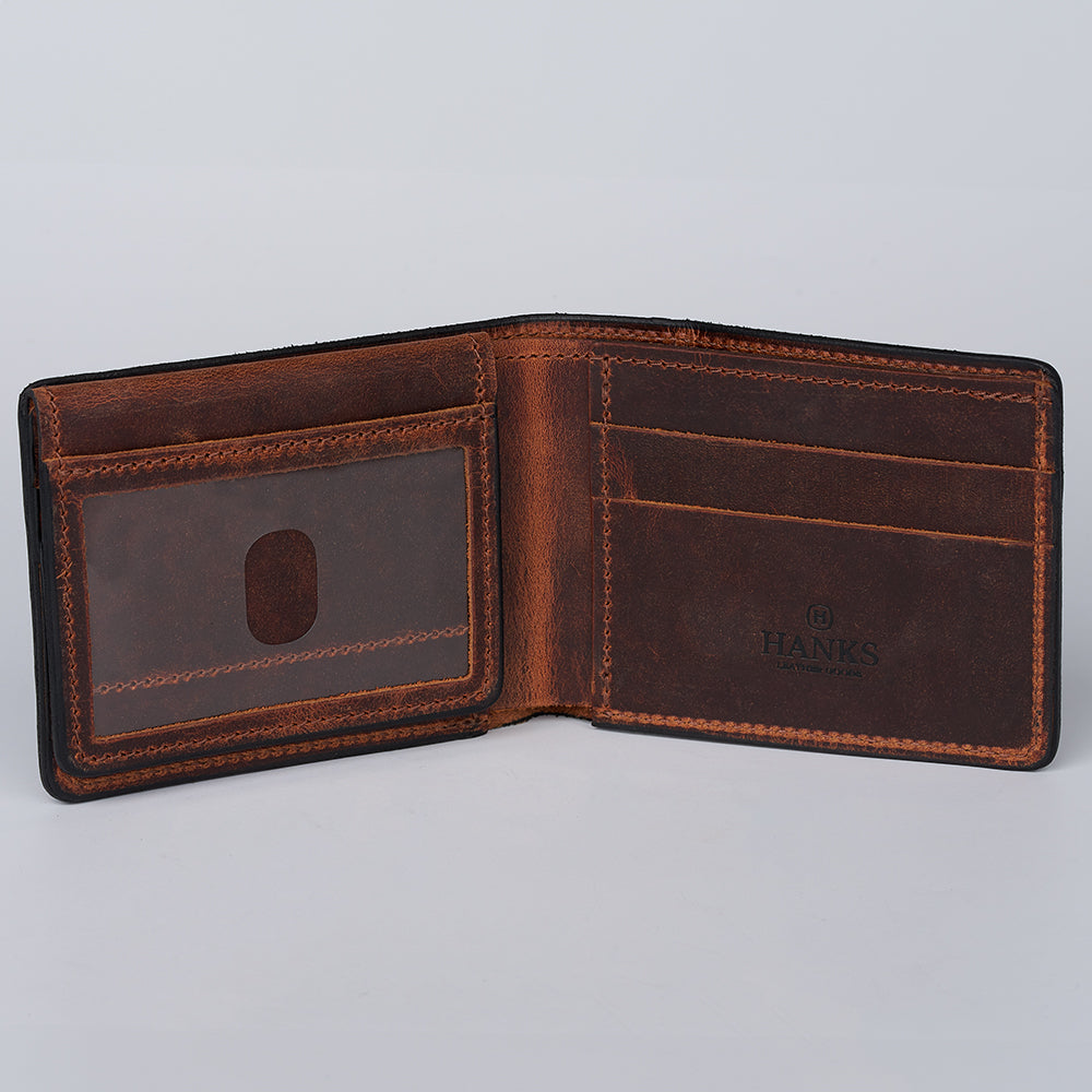 An open Huron Premium Bifold with ID Window by Hanks Belts in brown steerhide leather features card slots, a clear ID window, and &quot;HANKS&quot; embossed inside, made in USA, displayed against a plain white background.
