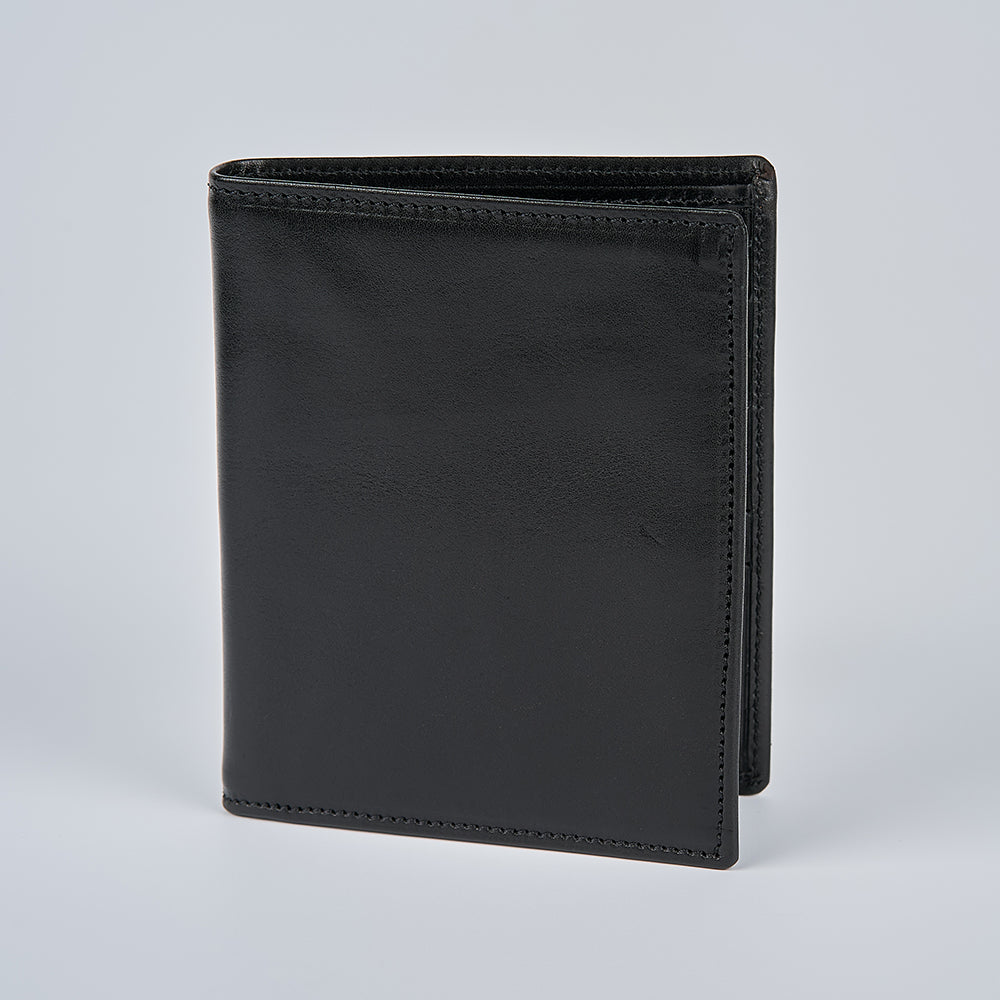 The Hanks Belts Iseo Italian Hipster Bifold, a black full-grain leather wallet with clean edge stitching and a smooth, minimalist design, stands upright on a plain light grey background.