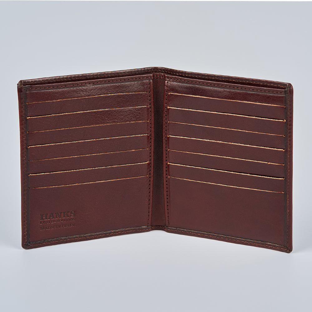 The Iseo Italian Hipster Bifold by Hanks Belts is an open brown full-grain leather wallet with multiple card slots on both sides, displayed upright on a plain light background. "HANKS" is embossed on the lower left corner.