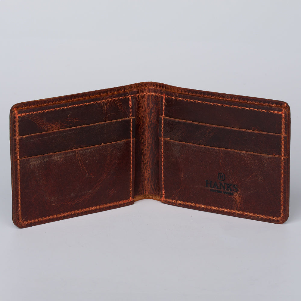 The Lanier Premium Bison Bifold by Hanks Belts is an open brown leather wallet with multiple card slots on each side and the &quot;Hanks&quot; logo stamped inside right. This empty, USA-made wallet is shown against a plain light background.