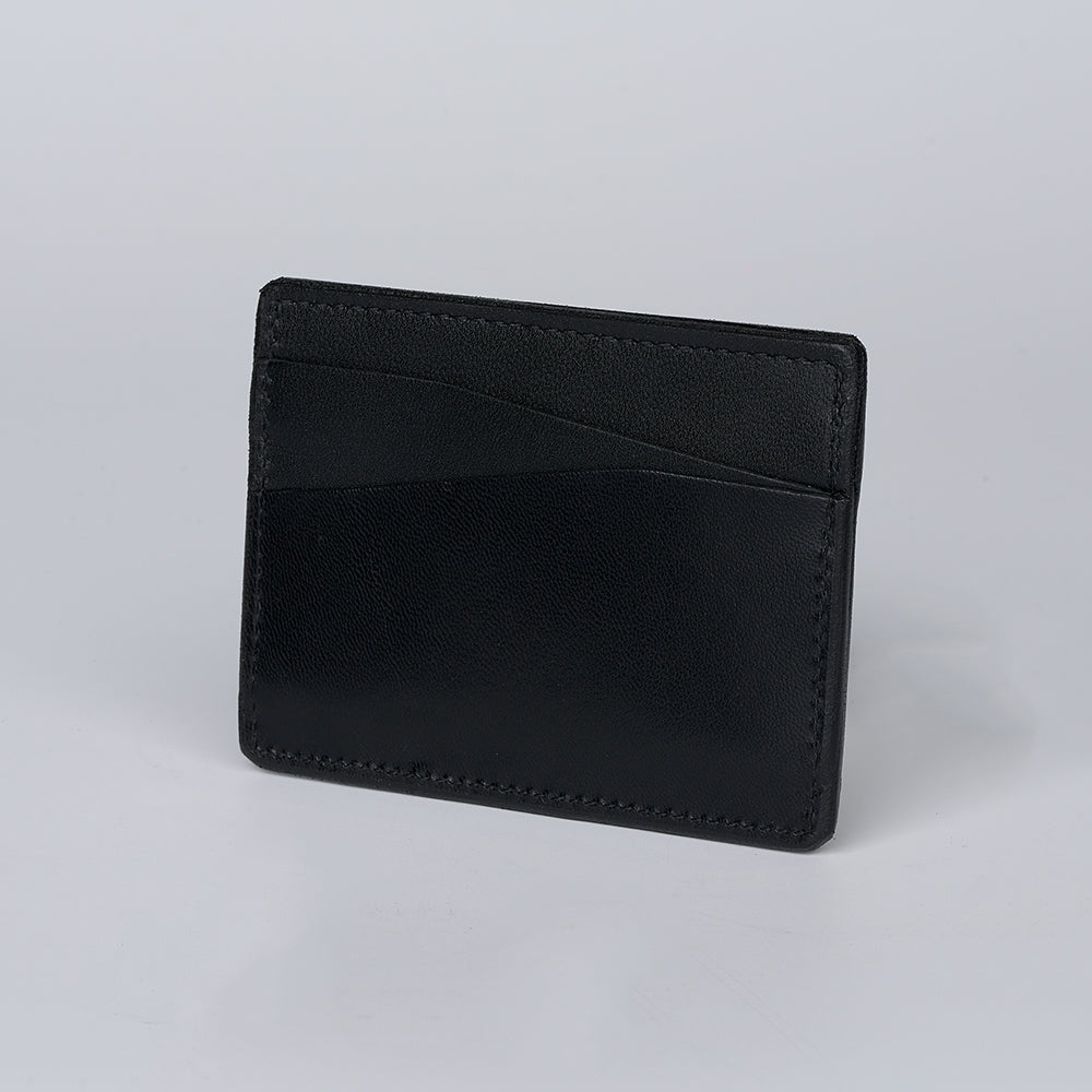 The Monroe Goatskin Card Holder by Hanks Belts stands upright on a light gray background, featuring two card slots for a sleek, minimalist wallet option.