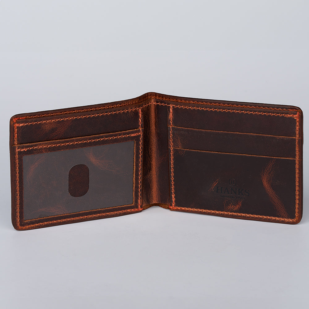 The Hanks Belts Ontario Premium Bison Bifold with ID Window is an open brown leather wallet with visible stitching, card slots on the right, and an ID window on the left, shown against a plain light background.